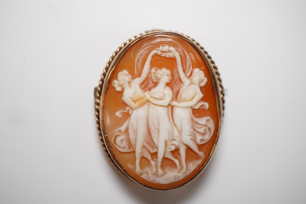 A yellow metal mounted oval cameo shell brooch, carved with The Three Graces, 30mm, gross weight 8 grams. Condition - fair